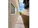Narrow side yard walkway between homes with block wall and palm tree view at 5384 Hanging Tree Ln, Las Vegas, NV 89118