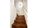 Staircase featuring hardwood steps and a white banister, leading upwards at 5384 Hanging Tree Ln, Las Vegas, NV 89118