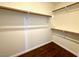 Walk-in closet featuring shelving with light-colored walls and hardwood floors at 5384 Hanging Tree Ln, Las Vegas, NV 89118