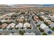 This aerial photo shows the neighborhood layout, with houses, streets, and distant mountain views at 5513 Oakview Falls Ct, Las Vegas, NV 89148
