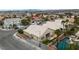 Aerial view showcases a home with a refreshing pool and landscaping at 5513 Oakview Falls Ct, Las Vegas, NV 89148