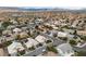 The aerial view captures the community, showcasing houses with solar panels and well-maintained streets at 5513 Oakview Falls Ct, Las Vegas, NV 89148