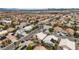 This aerial shot provides a view of the residential area with streets, houses, and green landscapes at 5513 Oakview Falls Ct, Las Vegas, NV 89148