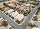 Aerial view showcases the homes, neighborhood streets, and lush landscaping of this residential area at 5513 Oakview Falls Ct, Las Vegas, NV 89148