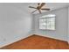 Bright bedroom features wood floors, a ceiling fan, and a window with natural light at 5513 Oakview Falls Ct, Las Vegas, NV 89148