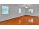 Spacious bedroom with wood floors and natural light from two windows at 5513 Oakview Falls Ct, Las Vegas, NV 89148