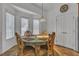 Cozy dining room featuring a round table with ornate chairs and a door at 5513 Oakview Falls Ct, Las Vegas, NV 89148