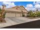 Single-story home with a three-car garage, desert landscaping, and mature trees, showcasing a well-maintained exterior at 5513 Oakview Falls Ct, Las Vegas, NV 89148