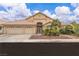 Charming single-story home with a three-car garage, desert landscaping, and a welcoming front entrance at 5513 Oakview Falls Ct, Las Vegas, NV 89148