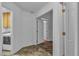 Hallway featuring tile flooring, white walls, and multiple doorways at 5513 Oakview Falls Ct, Las Vegas, NV 89148