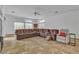 A spacious living room featuring tile floors and a large sofa at 5513 Oakview Falls Ct, Las Vegas, NV 89148