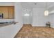 Bright living room with tile flooring, seamlessly connecting to the kitchen, with chandelier lighting and an open layout at 5513 Oakview Falls Ct, Las Vegas, NV 89148