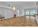 Spacious living room featuring tile flooring, neutral walls, large windows, and stylish chandelier lighting at 5513 Oakview Falls Ct, Las Vegas, NV 89148