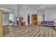 Spacious main bedroom with wood floors, a ceiling fan, and a sliding glass door at 5513 Oakview Falls Ct, Las Vegas, NV 89148