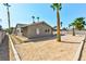 Charming home featuring a spacious, sand backyard complemented by mature palm trees at 5804 Maynard Ave, Las Vegas, NV 89108