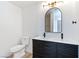 Stylish bathroom featuring a double sink vanity with a black wood grain cabinet and modern fixtures at 5804 Maynard Ave, Las Vegas, NV 89108