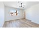 Bright bedroom featuring wood floors, modern lighting and a large window at 5804 Maynard Ave, Las Vegas, NV 89108