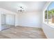 Spacious bedroom with wood flooring, a large window, and a mirrored closet at 5804 Maynard Ave, Las Vegas, NV 89108