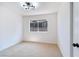 Bedroom with carpet flooring, a modern light fixture and door to the hallway at 5804 Maynard Ave, Las Vegas, NV 89108