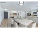 Bright open-concept dining room with modern lighting, hardwood floors, and an adjoining kitchen at 5804 Maynard Ave, Las Vegas, NV 89108
