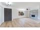 Open living space with a fireplace, modern flooring, and a view to the front door at 5804 Maynard Ave, Las Vegas, NV 89108