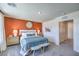 This staged bedroom features an accent wall, soft lighting, and cozy textures for a peaceful retreat at 6157 Aster Garden St # 153, North Las Vegas, NV 89081