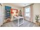 Inviting home office features bright walls, modern decor, a large window and a functional layout for productivity at 6157 Aster Garden St # 153, North Las Vegas, NV 89081
