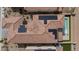 Overhead view of a property highlighting the roof, solar panels, and a private swimming pool with lounge area at 6545 Vanhoven Crest St, Las Vegas, NV 89166