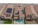 Aerial perspective featuring a backyard swimming pool, desert landscaping, and solar panels on the roof at 6545 Vanhoven Crest St, Las Vegas, NV 89166