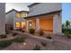 Backyard patio with desert landscaping leading to the back door of a two-story home at 6545 Vanhoven Crest St, Las Vegas, NV 89166