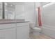 Bright bathroom features a tub with shower and large vanity at 6545 Vanhoven Crest St, Las Vegas, NV 89166