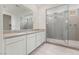 Modern bathroom features a large shower with gray subway tile and a double sink vanity at 6545 Vanhoven Crest St, Las Vegas, NV 89166