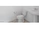 Bright half bathroom featuring patterned tile floor and pedestal sink at 6545 Vanhoven Crest St, Las Vegas, NV 89166