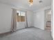 Spacious bedroom with natural light from a large window and neutral carpeting at 6545 Vanhoven Crest St, Las Vegas, NV 89166
