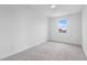 Bedroom with gray carpet, neutral paint, a window and base trim; ample natural light at 6545 Vanhoven Crest St, Las Vegas, NV 89166