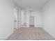 Bedroom with multiple entry points, carpet, and neutral paint; walk-in closet access at 6545 Vanhoven Crest St, Las Vegas, NV 89166