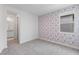 Cozy bedroom featuring patterned wallpaper and neutral carpet at 6545 Vanhoven Crest St, Las Vegas, NV 89166