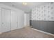 Bedroom with decorative wallpaper, carpet, and neutral paint; closet access on left at 6545 Vanhoven Crest St, Las Vegas, NV 89166