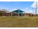 Expansive community park featuring play structures and picnic areas on a sunny day at 6545 Vanhoven Crest St, Las Vegas, NV 89166