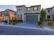 Charming two-story home with a paved driveway, two-car garage and desert landscaping at 6545 Vanhoven Crest St, Las Vegas, NV 89166