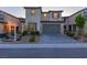 Attractive two-story home with a well-maintained front yard, two-car garage and desert landscaping at 6545 Vanhoven Crest St, Las Vegas, NV 89166