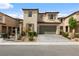 Charming two-story home with a two-car garage, desert landscaping, and a brick paver driveway at 6545 Vanhoven Crest St, Las Vegas, NV 89166