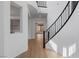 Elegant foyer boasts wood-look floors, modern staircase, and open layout, creating a welcoming and bright atmosphere at 6545 Vanhoven Crest St, Las Vegas, NV 89166