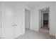 Hallway with neutral paint, carpet, and white trim; entry to bedroom on right at 6545 Vanhoven Crest St, Las Vegas, NV 89166