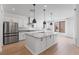 Large kitchen featuring a central island, stainless steel appliances, and stylish finishes at 6545 Vanhoven Crest St, Las Vegas, NV 89166