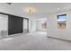 Spacious primary bedroom with light gray carpet and a stylish modern ceiling light fixture at 6545 Vanhoven Crest St, Las Vegas, NV 89166