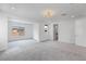 Unfurnished primary bedroom with light gray carpet, modern ceiling light, and attached bathroom at 6545 Vanhoven Crest St, Las Vegas, NV 89166