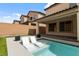 Backyard pool with in-water lounge chairs offers a refreshing retreat, complemented by manicured landscaping and privacy walls at 6545 Vanhoven Crest St, Las Vegas, NV 89166