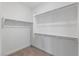 Compact walk-in closet with carpet, rods and shelves maximizing space at 6545 Vanhoven Crest St, Las Vegas, NV 89166