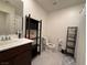 Bright bathroom featuring a toilet, sink with vanity, and shelving unit at 6999 Bard Ave, Las Vegas, NV 89113